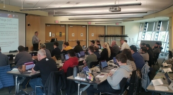 A classroom full of adults with laptops